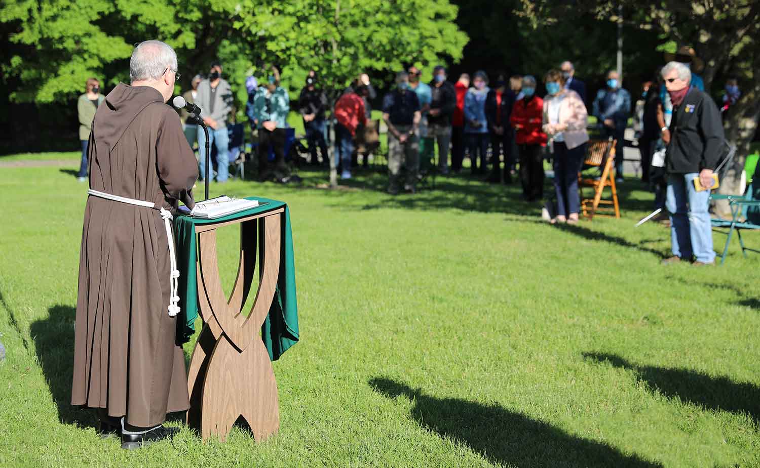 Fr. Tom Zelinski, Capuchin, addresses visitors on the front lawn of the retreat house.