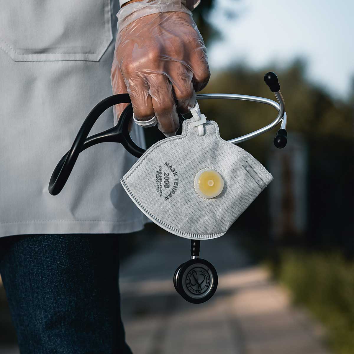 Health care worker holding stethoscope and N95 facemaks