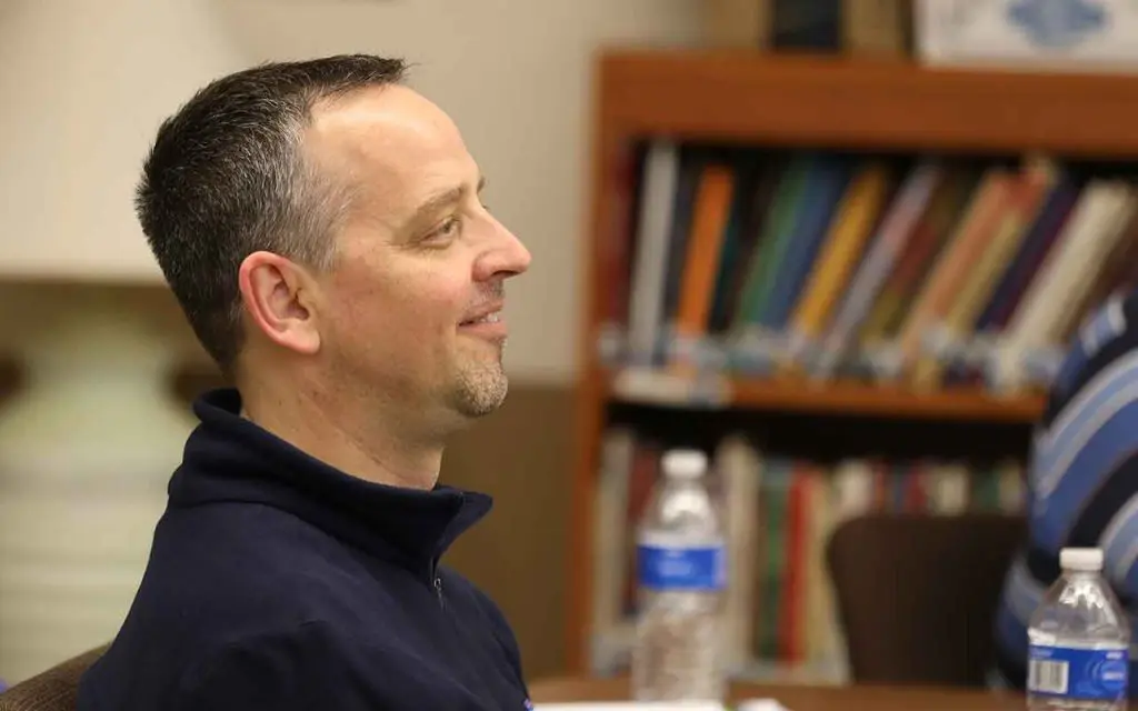 Smiling man attending a session at Capuchin Retreat