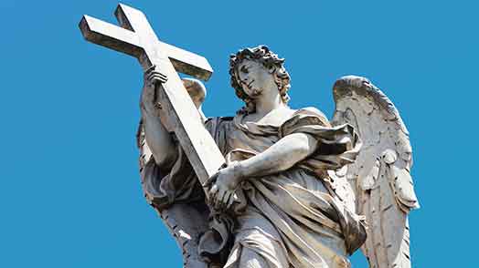 Photograph of an angel holding a cross